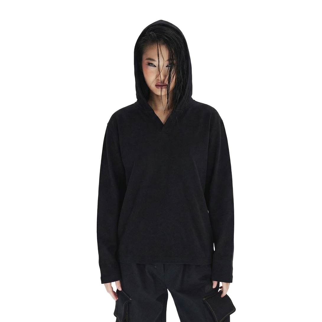 Person wearing a black hoodie and pants on a white background