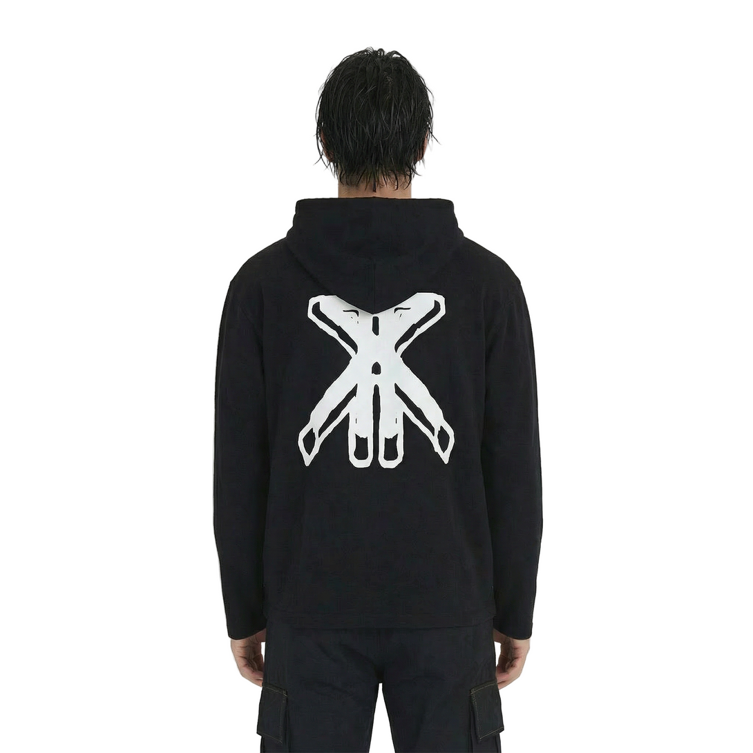 Person wearing a black hoodie with a white logo on the back against a plain background