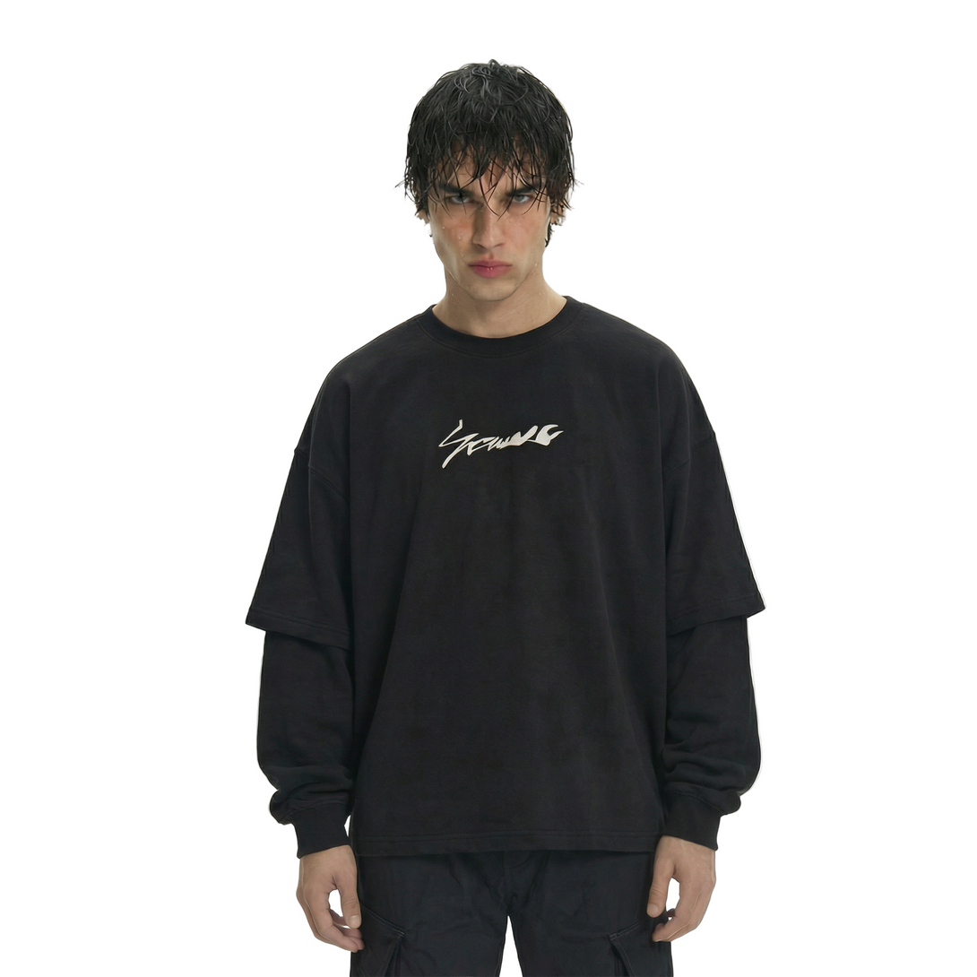 Person wearing a black sweatshirt with white text on a white background
