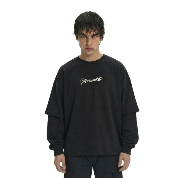 Person wearing a black sweatshirt with white text on a white background